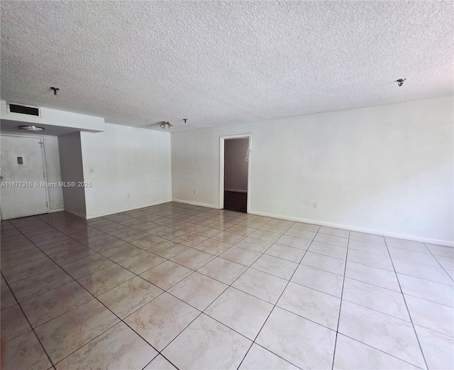 661 NE 195th St Unit 215, Miami, FL 33179 - spare room with a textured ceiling, light tile patterned floors, and a pendent fire sprinkler
