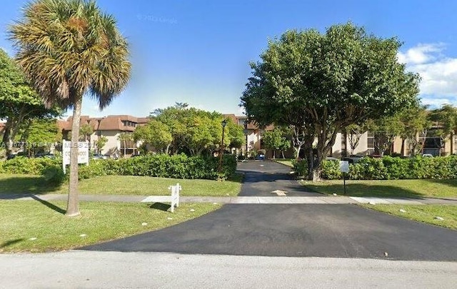 661 NE 195th St Unit 215, Miami, FL 33179 - view of front of property featuring a front lawn and a residential view