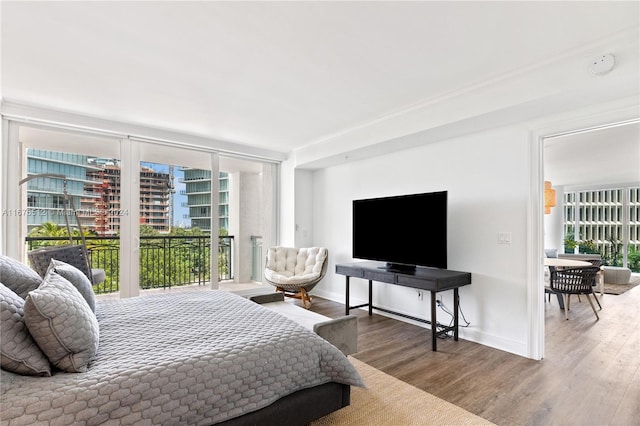 bedroom with hardwood / wood-style flooring and access to outside