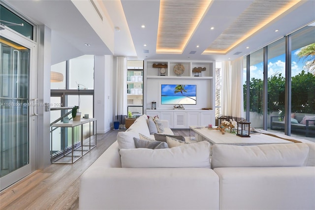 living room featuring light hardwood / wood-style flooring and floor to ceiling windows