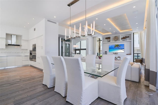 dining area with hardwood / wood-style floors and a chandelier