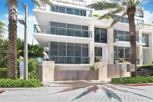 9501 Collins Ave Unit Th1, Surfside, FL 33154 - view of building exterior with decorative driveway and fence