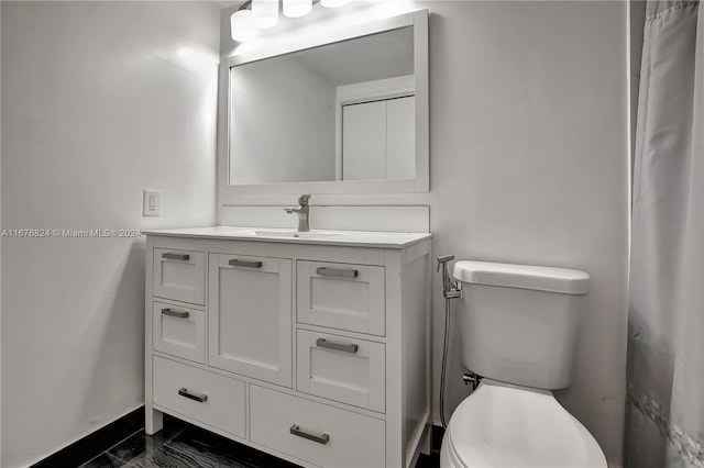 bathroom featuring toilet and vanity