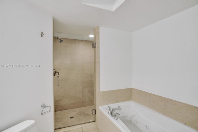 bathroom with toilet, tile patterned floors, and shower with separate bathtub