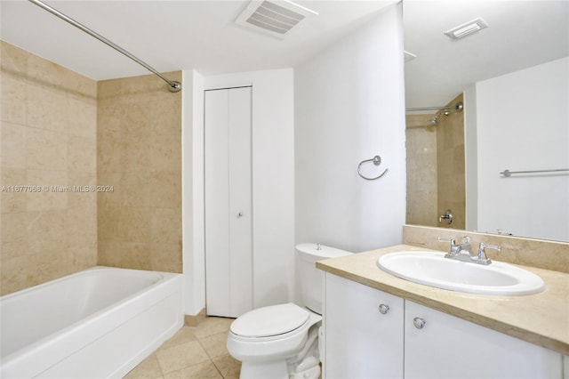 full bathroom featuring toilet, tiled shower / bath combo, vanity, and tile patterned floors