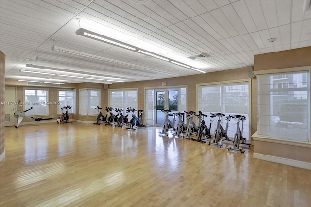 exercise room featuring french doors and light wood-type flooring