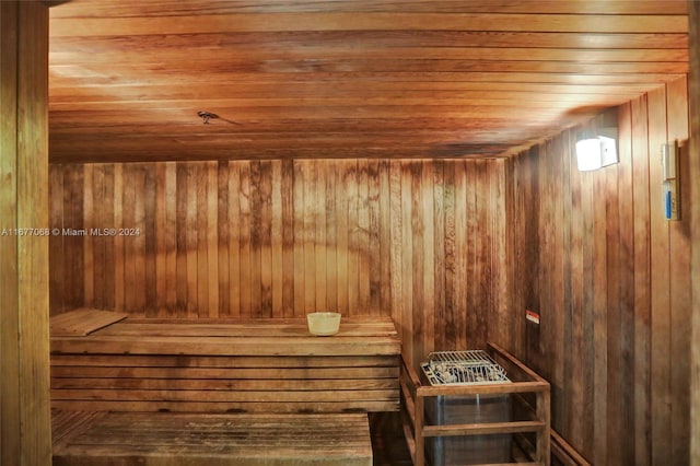 view of sauna / steam room with wood ceiling and wooden walls