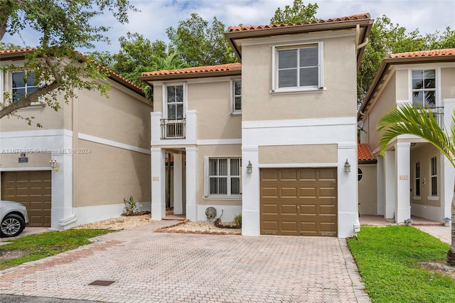 mediterranean / spanish-style house with a garage