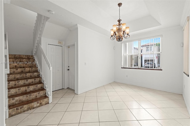 unfurnished dining area with a notable chandelier, a raised ceiling, light tile patterned floors, and crown molding