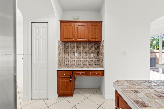 kitchen featuring tasteful backsplash, tile counters, and light tile patterned flooring