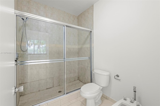 bathroom featuring an enclosed shower, tile patterned floors, a bidet, and toilet