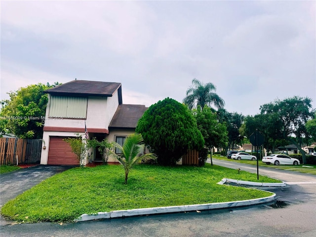 view of front of home with a garage and a front yard