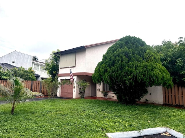 exterior space featuring a lawn and a garage