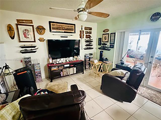 tiled living room featuring ceiling fan and french doors