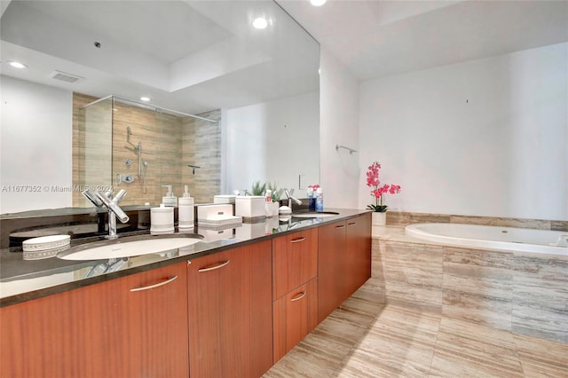 bathroom with vanity and plus walk in shower