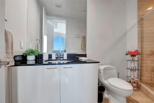 bathroom featuring vanity, hardwood / wood-style floors, and toilet