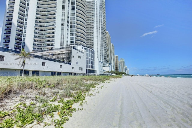 view of property featuring a water view and a view of the beach