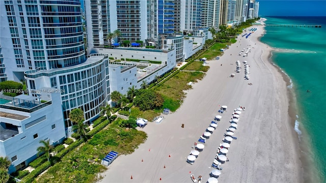 birds eye view of property with a water view and a view of the beach