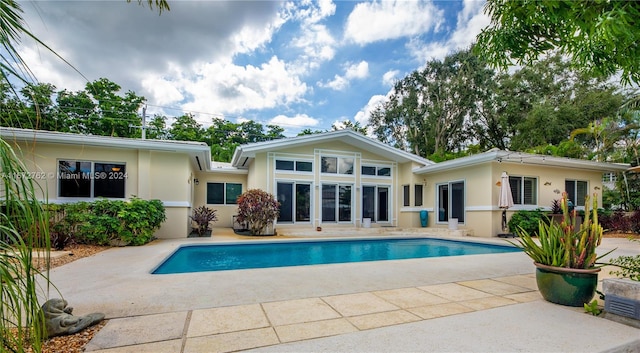 back of property with a patio