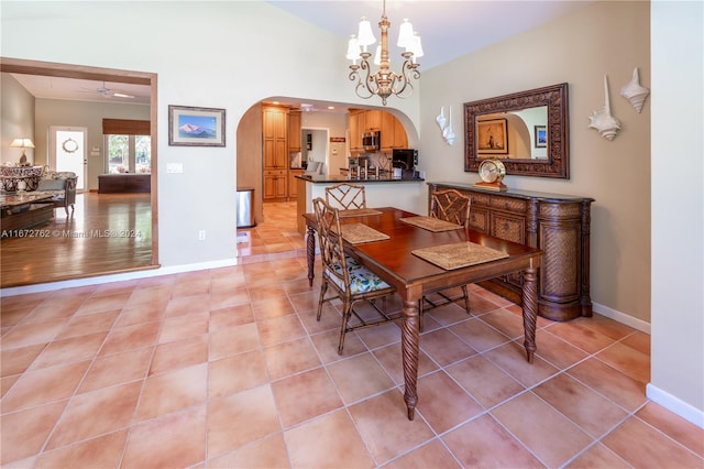 dining area featuring light wood-type flooring and ceiling fan with notable chandelier