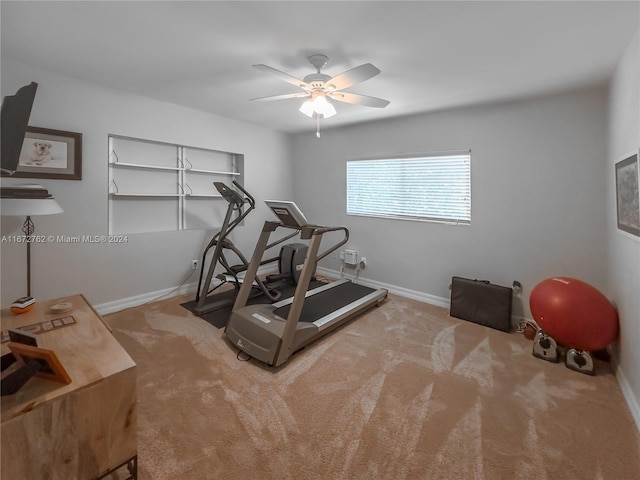 exercise room featuring light carpet and ceiling fan