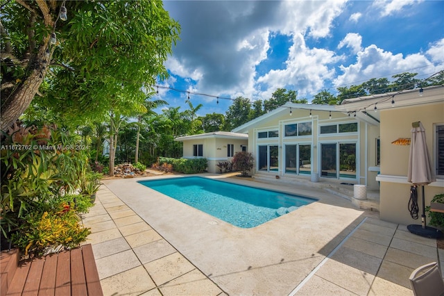 view of swimming pool featuring a patio area