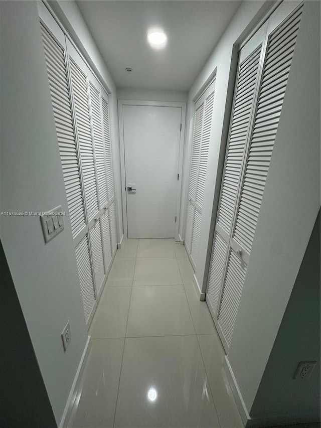 hall with light tile patterned flooring