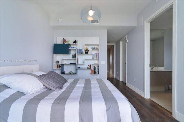 bedroom featuring sink and dark hardwood / wood-style flooring