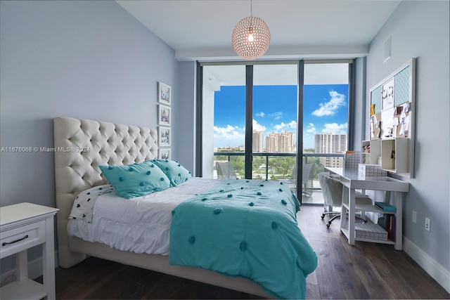 bedroom featuring a wall of windows, multiple windows, and dark hardwood / wood-style floors
