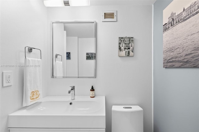 bathroom with toilet and vanity