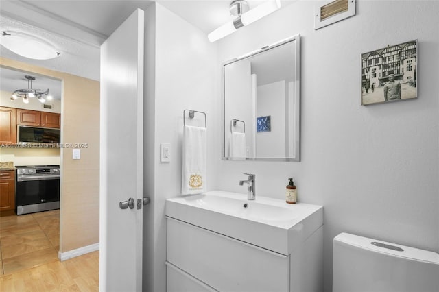 bathroom with hardwood / wood-style floors, toilet, and vanity