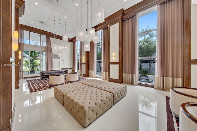 bedroom featuring tile patterned floors and a high ceiling