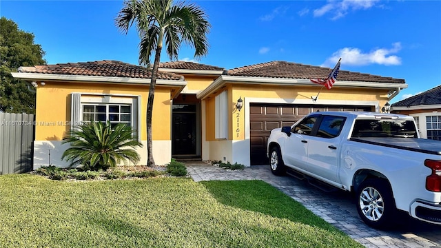 view of front facade with a front yard and a garage