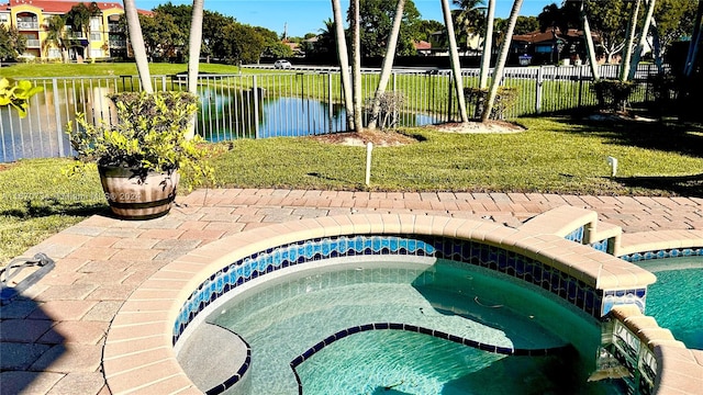 view of swimming pool featuring a water view, an in ground hot tub, and a yard