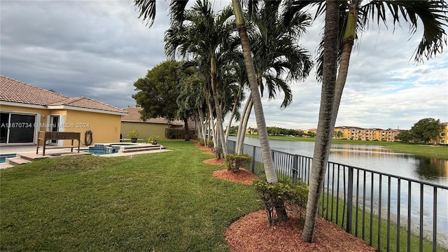 view of yard with a water view and a patio area