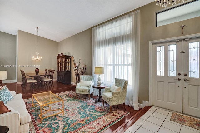 foyer entrance featuring light hardwood / wood-style flooring and a notable chandelier