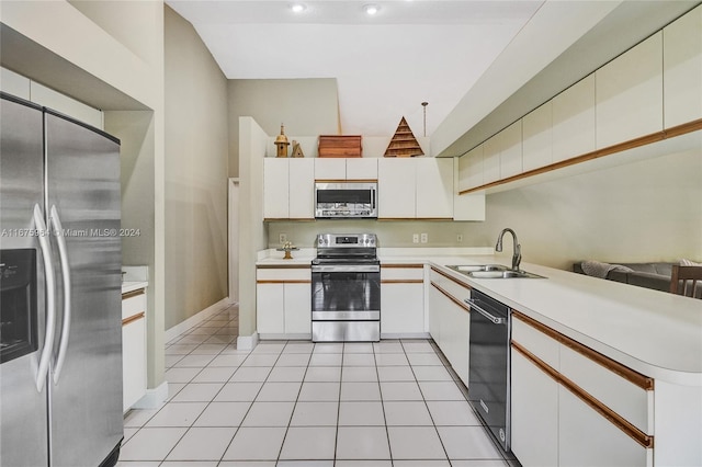 kitchen featuring stainless steel appliances, white cabinetry, sink, and light tile patterned floors