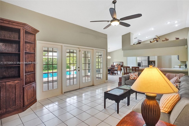 tiled living room with ceiling fan, french doors, and lofted ceiling