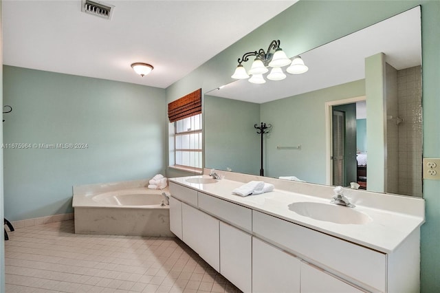 bathroom featuring tile patterned flooring, a bath, and vanity