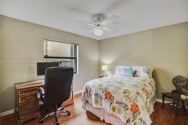 bedroom featuring wood-type flooring, ceiling fan, and a textured ceiling