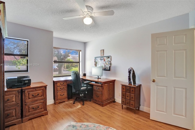 home office featuring ceiling fan, a textured ceiling, and light hardwood / wood-style flooring