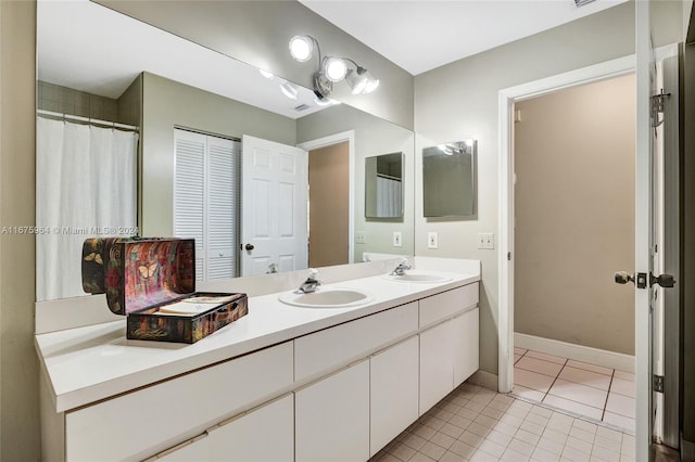 bathroom featuring tile patterned flooring and vanity