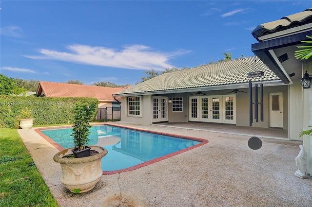 view of swimming pool with a patio area, french doors, and ceiling fan