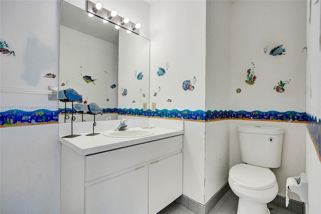 bathroom with vanity, tile patterned floors, and toilet