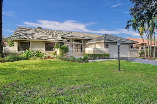 view of front of home with a garage and a front lawn