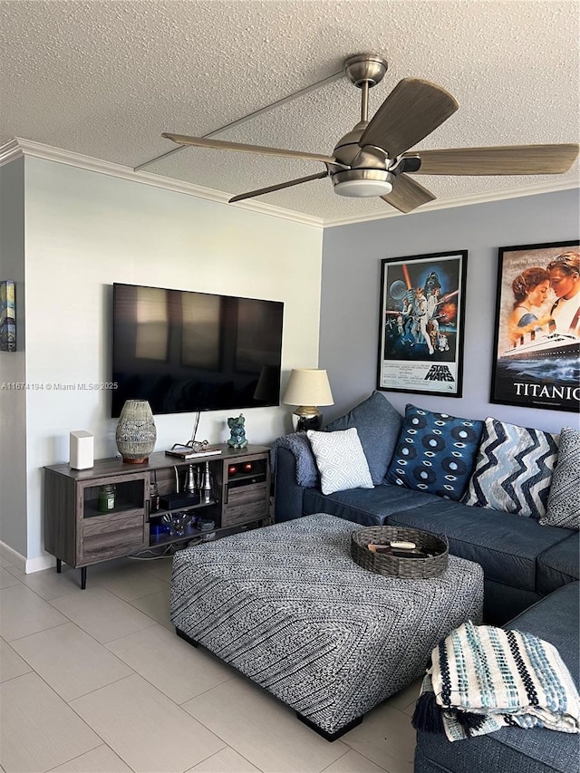 living room featuring ceiling fan, crown molding, light tile patterned floors, and a textured ceiling