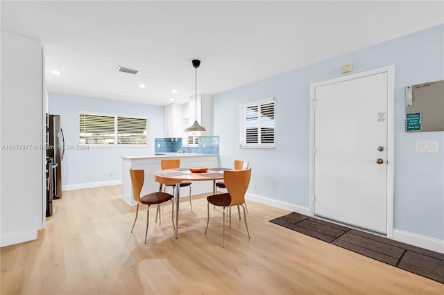 dining space featuring light hardwood / wood-style floors