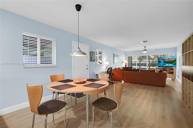 dining room with light hardwood / wood-style floors and ceiling fan