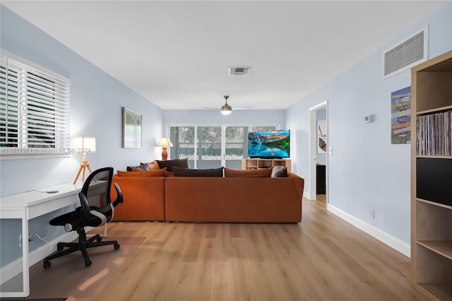 living room featuring ceiling fan and light wood-type flooring