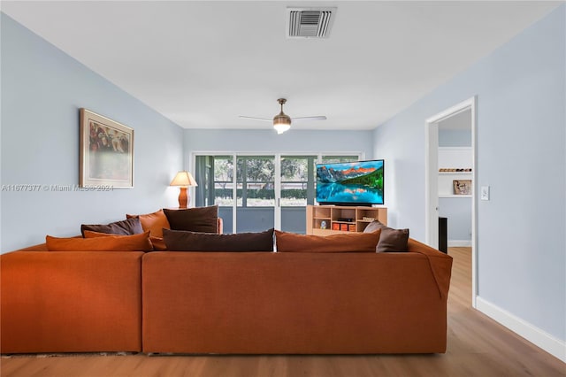 living room featuring wood-type flooring and ceiling fan